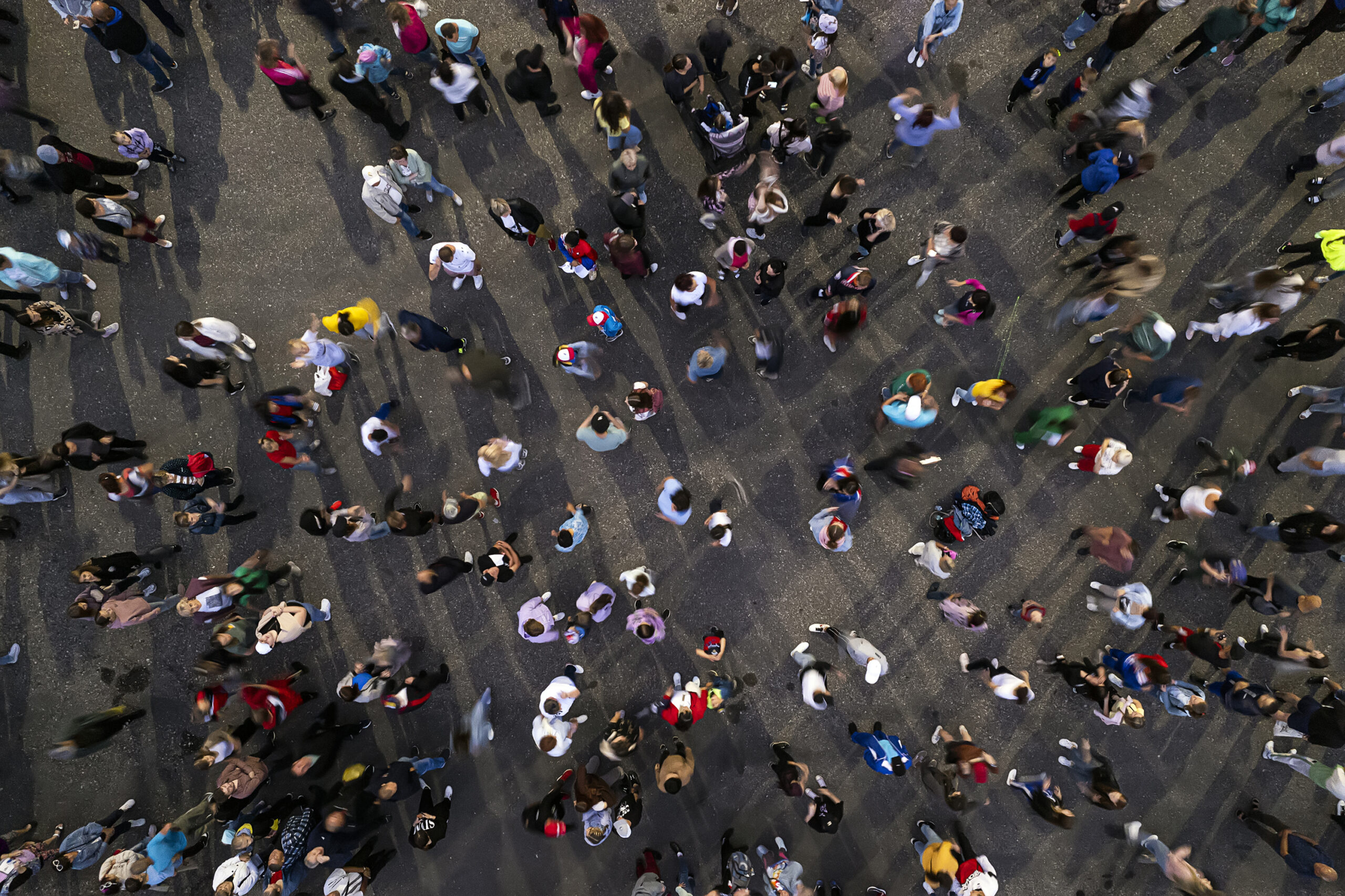 crowd background. An aerial shot of the people gathered for an event. Crowed open-air meeting people shot from a height. A mass people gathered to celebrate an event. Open-air night festival.