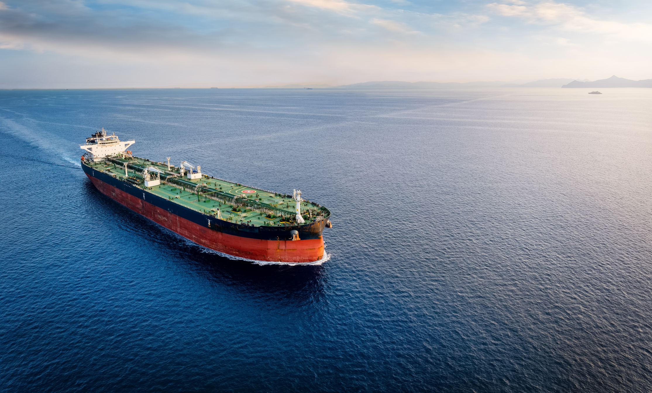 Aerial view of a large crude oil tanker traveling over open ocean with copy space
