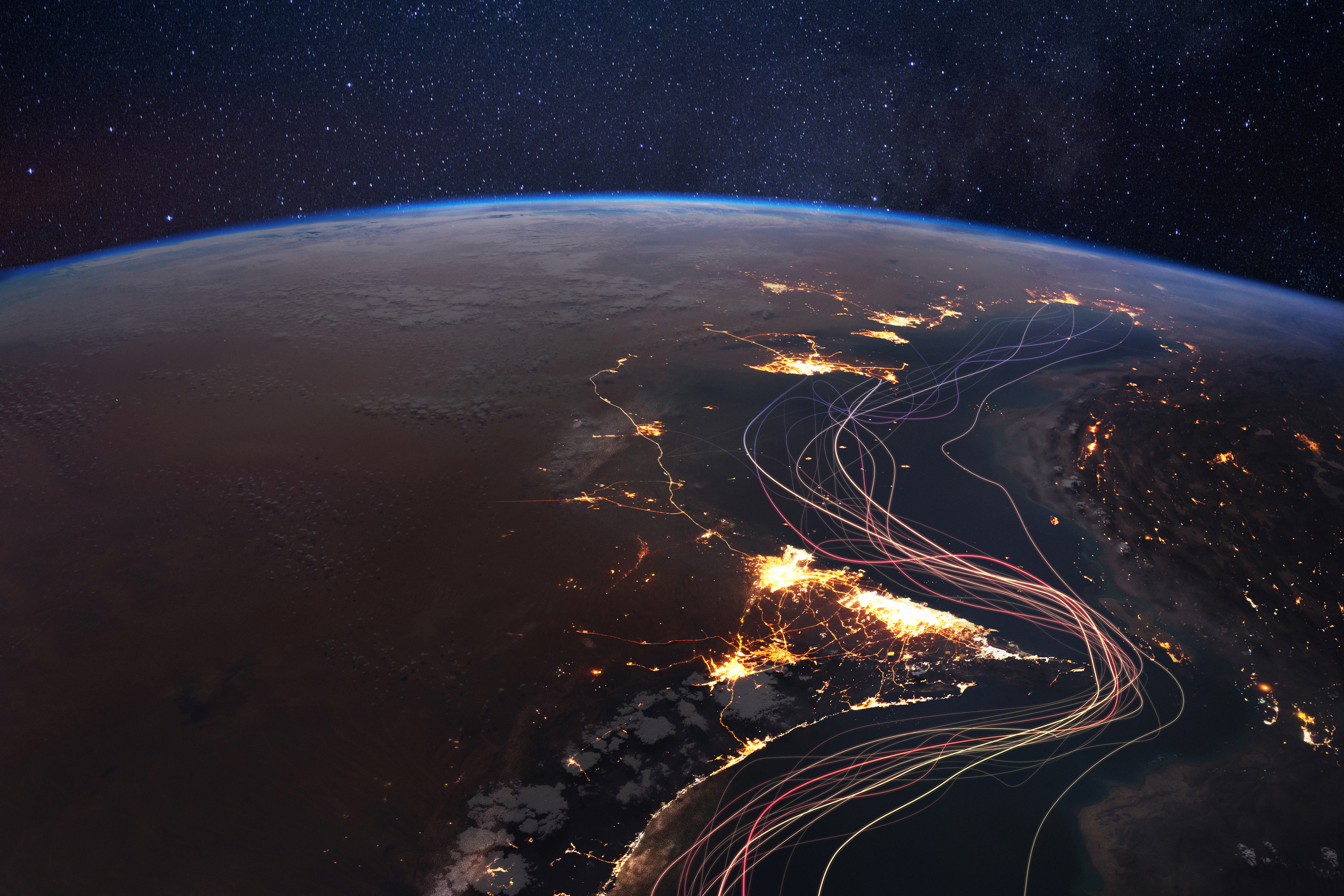 Strategic satellite view of the Strait of Hormuz at night with illuminated shipping lanes. Abstract light trails represent global trade, oil logistics, and maritime traffic in the Persian Gulf
https://www.flickr.com/photos/nasa2explore/53118772399/
